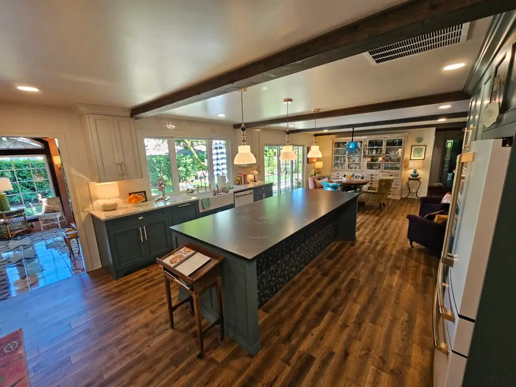 Wide kitchen with hardwood flooring running through to the dining area