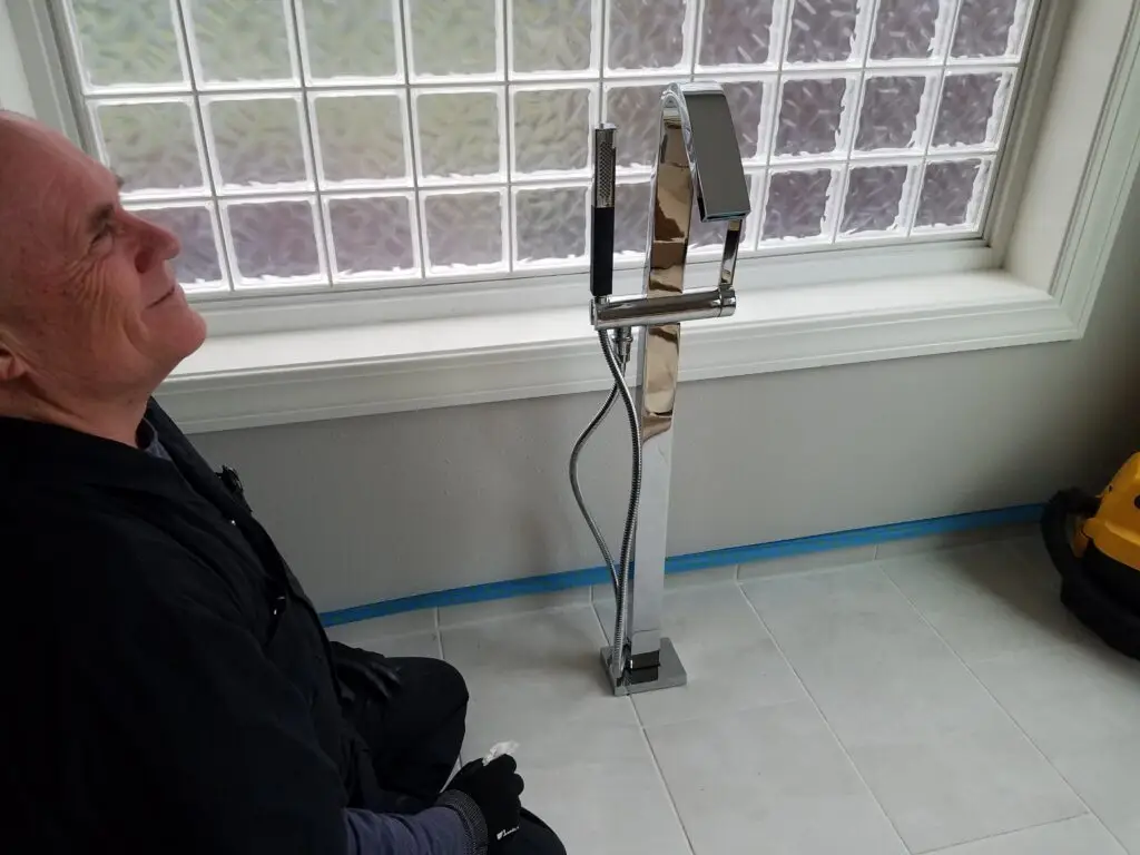 TLC Home Solutions contractor working on a window opening during exterior replacement