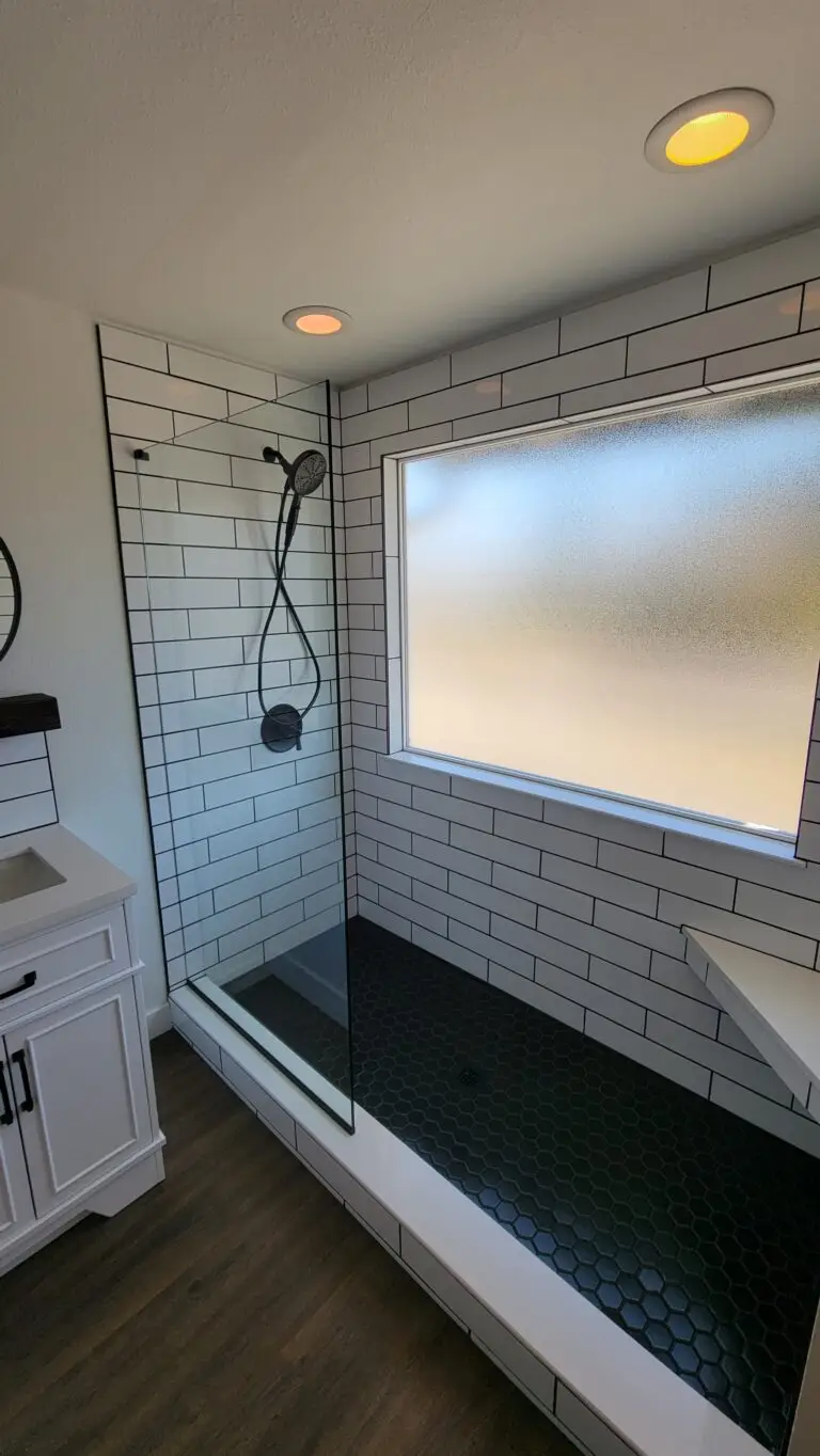 Walk-in subway tile shower with a low threshold and hand shower