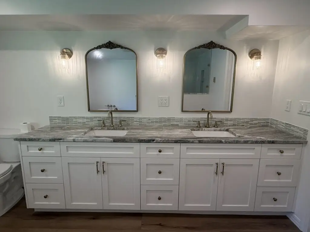New double vanity with white shaker cabinets, granite countertop, undermount sinks and arched mirrors in a remodeled Camas, WA master bathroom
