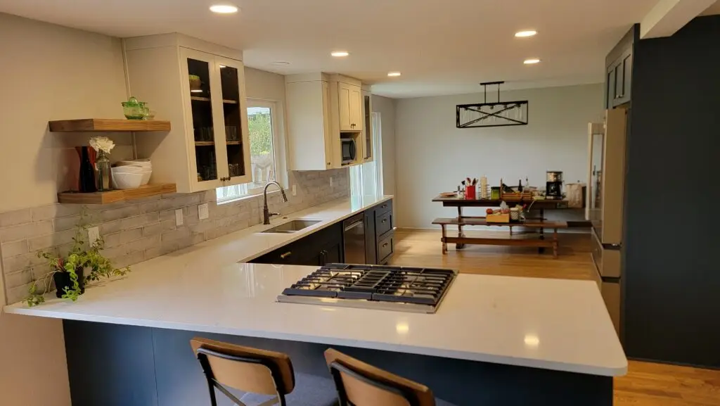 Remodeled kitchen peninsula with quartz countertops, floating wood shelves and a gas cooktop in Vancouver, WA